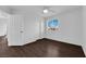 Bright bedroom featuring wood-look floors, a window with blinds, and a ceiling fan at 5124 Veeder Crest St, North Las Vegas, NV 89081