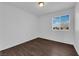 Cozy bedroom with wood-look floors and window providing natural light at 5124 Veeder Crest St, North Las Vegas, NV 89081