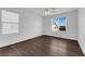 Bedroom featuring wood-look flooring, two windows, and ample natural light at 5124 Veeder Crest St, North Las Vegas, NV 89081