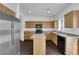 Modern kitchen features stainless steel appliances, wood cabinets, and center island at 5124 Veeder Crest St, North Las Vegas, NV 89081