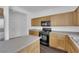 Well-lit kitchen with wood cabinets and stainless steel appliances at 5124 Veeder Crest St, North Las Vegas, NV 89081