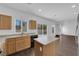 Bright kitchen featuring wood cabinets and an island, seamlessly connecting to the dining area at 5124 Veeder Crest St, North Las Vegas, NV 89081