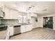 Modern kitchen with stainless steel appliances, gray backsplash, and updated cabinets at 5310 Plainfield Dr, Las Vegas, NV 89142