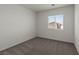 Cozy bedroom with neutral carpet and large window at 6282 Blood Lily Ave, Las Vegas, NV 89122