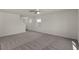 Bright living room with neutral carpet, ceiling fan, and ample natural light at 6282 Blood Lily Ave, Las Vegas, NV 89122