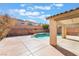 Refreshing pool with a spa and a covered patio area surrounded by a block wall at 63 Crescent Palm Ct, Henderson, NV 89002