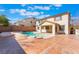 The backyard has a refreshing pool with a spa and a covered patio area at 63 Crescent Palm Ct, Henderson, NV 89002