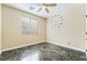This bedroom has sleek, dark floors, a ceiling fan, and a clock on the wall at 63 Crescent Palm Ct, Henderson, NV 89002