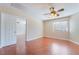 Bedroom with wood-look flooring, ceiling fan, and natural light at 63 Crescent Palm Ct, Henderson, NV 89002