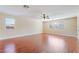 Bedroom with wood floors, fan, large window, and neutral walls at 63 Crescent Palm Ct, Henderson, NV 89002