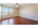 Bedroom featuring wood-look floors, ceiling fan, and windows at 63 Crescent Palm Ct, Henderson, NV 89002