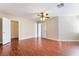 Large bedroom featuring wood floors, ceiling fan with light, and a walk-in closet at 63 Crescent Palm Ct, Henderson, NV 89002