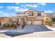 Charming two-story home featuring a two-car garage, manicured landscaping, and a welcoming entrance at 63 Crescent Palm Ct, Henderson, NV 89002