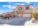 Inviting two-story home showcasing a two-car garage, desert landscaping, and a well-maintained front yard at 63 Crescent Palm Ct, Henderson, NV 89002