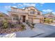 Beautiful two-story home featuring a two-car garage and desert landscaping in a well-maintained community at 63 Crescent Palm Ct, Henderson, NV 89002