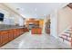 Bright kitchen features wood cabinets, stainless appliances, a center island and tile backsplash at 63 Crescent Palm Ct, Henderson, NV 89002