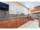 Modern kitchen with stainless steel appliances, granite countertops, and a stylish backsplash at 63 Crescent Palm Ct, Henderson, NV 89002