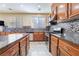 View of kitchen featuring stainless steel appliances, tile backsplash, tile floor and a center island at 63 Crescent Palm Ct, Henderson, NV 89002