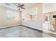 Open-concept living room adjacent to a dining area, with neutral tones and lots of natural light at 63 Crescent Palm Ct, Henderson, NV 89002