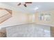 Open-concept living room with staircase, featuring lots of natural light and neutral tones at 63 Crescent Palm Ct, Henderson, NV 89002
