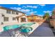Backyard pool and spa with a covered patio for outdoor entertaining on a sunny day at 63 Crescent Palm Ct, Henderson, NV 89002