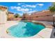 Private backyard pool with tanning shelf and water feature for a relaxing outdoor space at 63 Crescent Palm Ct, Henderson, NV 89002