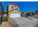 Inviting two-story home highlighting a spacious garage and a meticulously maintained yard, adding curb appeal to the property at 6424 Bombax Ct, Las Vegas, NV 89141