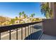 Balcony view of palm trees and landscaping with houses in the background at 6493 Za Zu Pitts Ave # 101, Las Vegas, NV 89122