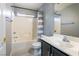 Bathroom featuring sink and tub with tile surround and shower at 6493 Za Zu Pitts Ave # 101, Las Vegas, NV 89122
