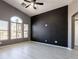 Bedroom featuring neutral tones, an arched window, and tile flooring at 6493 Za Zu Pitts Ave # 101, Las Vegas, NV 89122
