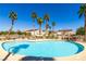 Community pool surrounded by palm trees and lounge chairs at 6493 Za Zu Pitts Ave # 101, Las Vegas, NV 89122