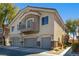 Two-story home featuring multi-car garages, balcony and neutral toned stucco exterior at 6493 Za Zu Pitts Ave # 101, Las Vegas, NV 89122