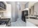 Well-lit kitchen with stainless steel appliances, modern sink and tile floors at 6493 Za Zu Pitts Ave # 101, Las Vegas, NV 89122