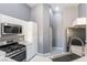 Well-lit kitchen with stainless steel appliances, modern sink and tile floors at 6493 Za Zu Pitts Ave # 101, Las Vegas, NV 89122