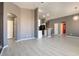 Open concept living area featuring modern lighting, sleek flooring and neutral tones at 6493 Za Zu Pitts Ave # 101, Las Vegas, NV 89122