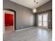 Neutral toned living room featuring modern lighting, tile flooring and french doors at 6493 Za Zu Pitts Ave # 101, Las Vegas, NV 89122