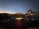 Scenic street view of a well-maintained community at dusk with palm trees and mountain views at 6493 Za Zu Pitts Ave # 101, Las Vegas, NV 89122