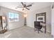 This bedroom features a ceiling fan, carpet flooring, large mirror and a bright window at 6637 Rockhouse St, North Las Vegas, NV 89086