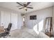 This bedroom features a ceiling fan, neutral walls, carpeted floors, and a wall-mounted TV for cozy relaxation at 6637 Rockhouse St, North Las Vegas, NV 89086