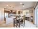 Modern kitchen with stainless steel appliances, a granite island, pendant lights, and an adjacent dining area at 6637 Rockhouse St, North Las Vegas, NV 89086