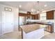 Elegant kitchen with stainless steel appliances, granite countertops, dark wood cabinetry, and a large center island at 6637 Rockhouse St, North Las Vegas, NV 89086