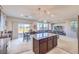 Open-concept living room with a kitchen island, dining table, and sliding glass doors for seamless indoor/outdoor living at 6637 Rockhouse St, North Las Vegas, NV 89086