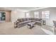 Spacious living room features a large sectional sofa, carpet flooring and lots of windows at 6637 Rockhouse St, North Las Vegas, NV 89086