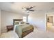 Comfortable main bedroom with a ceiling fan, carpet flooring and a large window at 6637 Rockhouse St, North Las Vegas, NV 89086