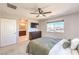 Main bedroom featuring a ceiling fan, TV, carpet flooring and an ensuite bathroom at 6637 Rockhouse St, North Las Vegas, NV 89086