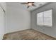 Cozy bedroom featuring a ceiling fan, neutral walls, plush carpeting, and a bright window at 6806 Chargehand Ave, Las Vegas, NV 89156