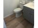 Small bathroom featuring a toilet and sink with gray wood cabinets at 6965 Coral Rock Dr, Las Vegas, NV 89108