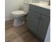 Bathroom featuring a toilet and sink with gray wood cabinets at 6965 Coral Rock Dr, Las Vegas, NV 89108