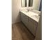 Bathroom featuring double sink vanity with white countertop, modern fixtures, and ample storage at 6965 Coral Rock Dr, Las Vegas, NV 89108