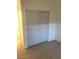 Bedroom with neutral colored carpet and sliding closet doors at 6965 Coral Rock Dr, Las Vegas, NV 89108